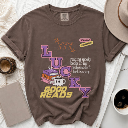 Brown t-shirt with "Lucky" text, ghost mug, books, and "Good Reads" slogan.