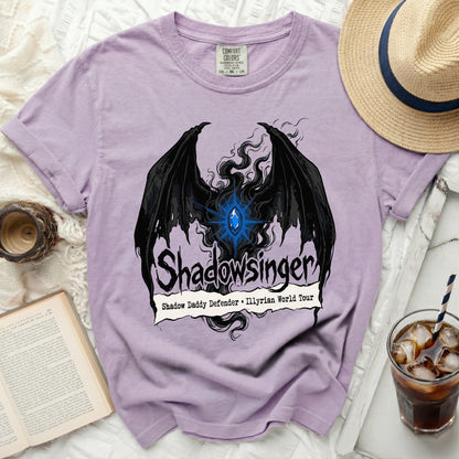 Lavender t-shirt with black wings, blue gem, and "Shadowsinger" text.