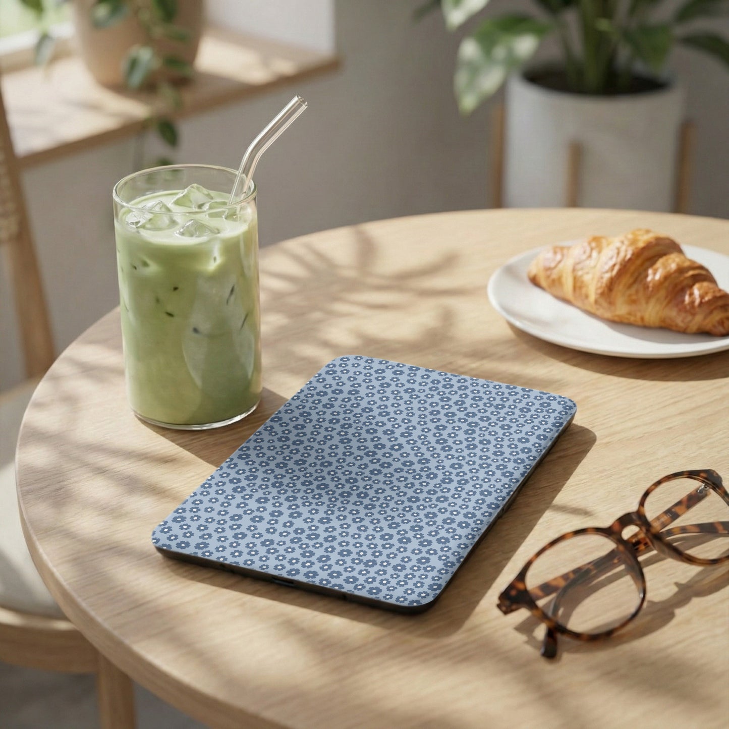 Blue Patterned Case on Wooden Table with Iced Green Drink