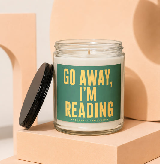 Glass jar candle with green label reading "GO AWAY, I'M READING".
