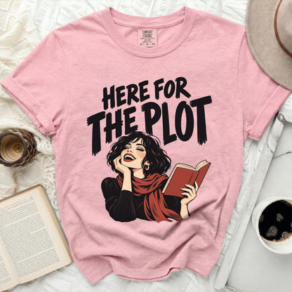 Pink t-shirt with "HERE FOR THE PLOT" text and illustration of a woman reading.