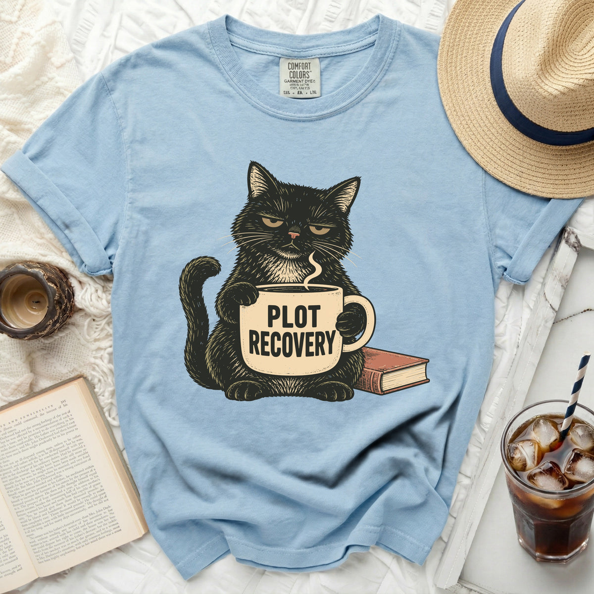 Black cat holding coffee mug with "PLOT RECOVERY" text and a book.