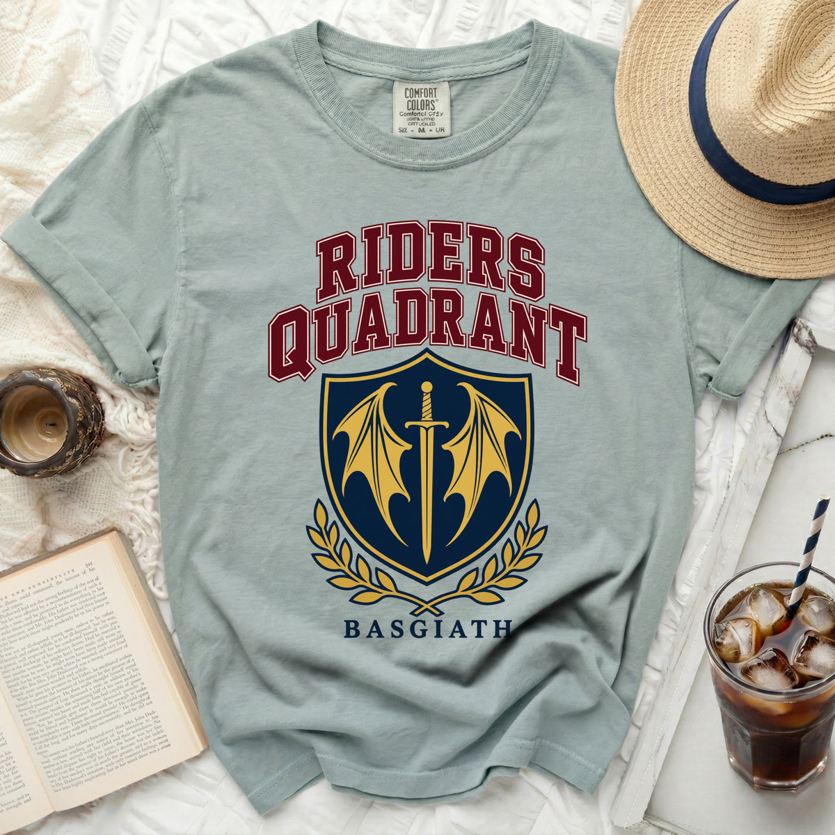 Light blue t-shirt with "Riders Quadrant Basgiath" text and a sword and wings crest.