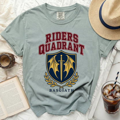 Light blue t-shirt with "Riders Quadrant Basgiath" text and a sword and wings crest.