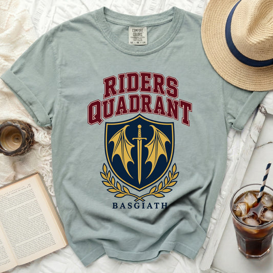 Light blue t-shirt with "Riders Quadrant Basgiath" text and a sword and wings crest.