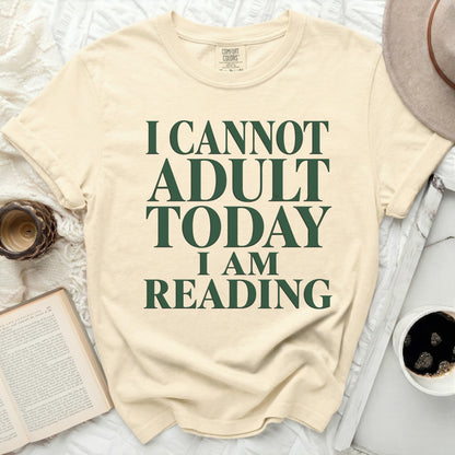 Cream t-shirt with green text "I CANNOT ADULT TODAY I AM READING."