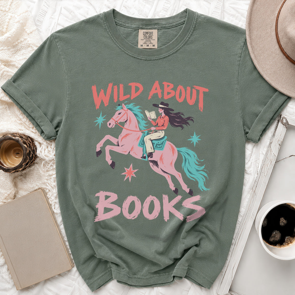 Green t-shirt with "Wild About Books" graphic featuring a cowgirl reading on a pink horse.