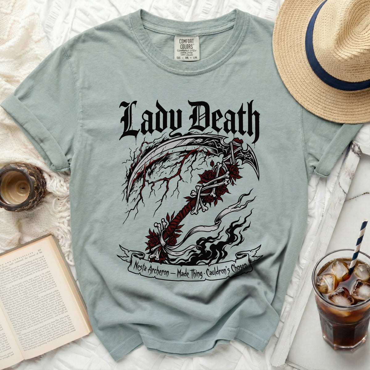 Pale blue t-shirt with "Lady Death" and a scythe graphic.