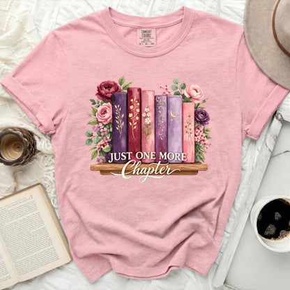 Pink t-shirt with "Just One More Chapter" and floral book graphic.