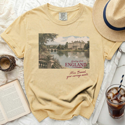 Yellow Comfort Colors t-shirt with "Greetings from England. Miss Bennet, your carriage awaits" graphic.