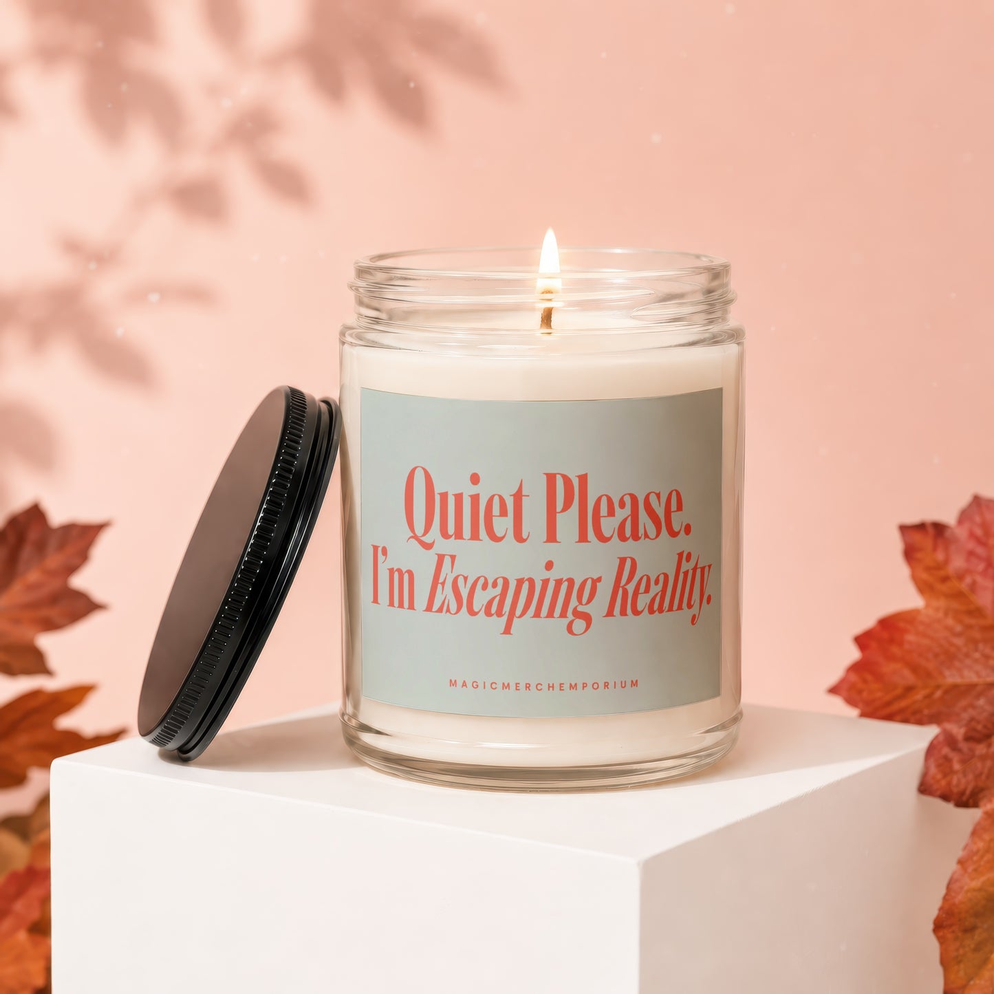 Candle with "Quiet Please. I'm Escaping Reality." text on a light blue label.
