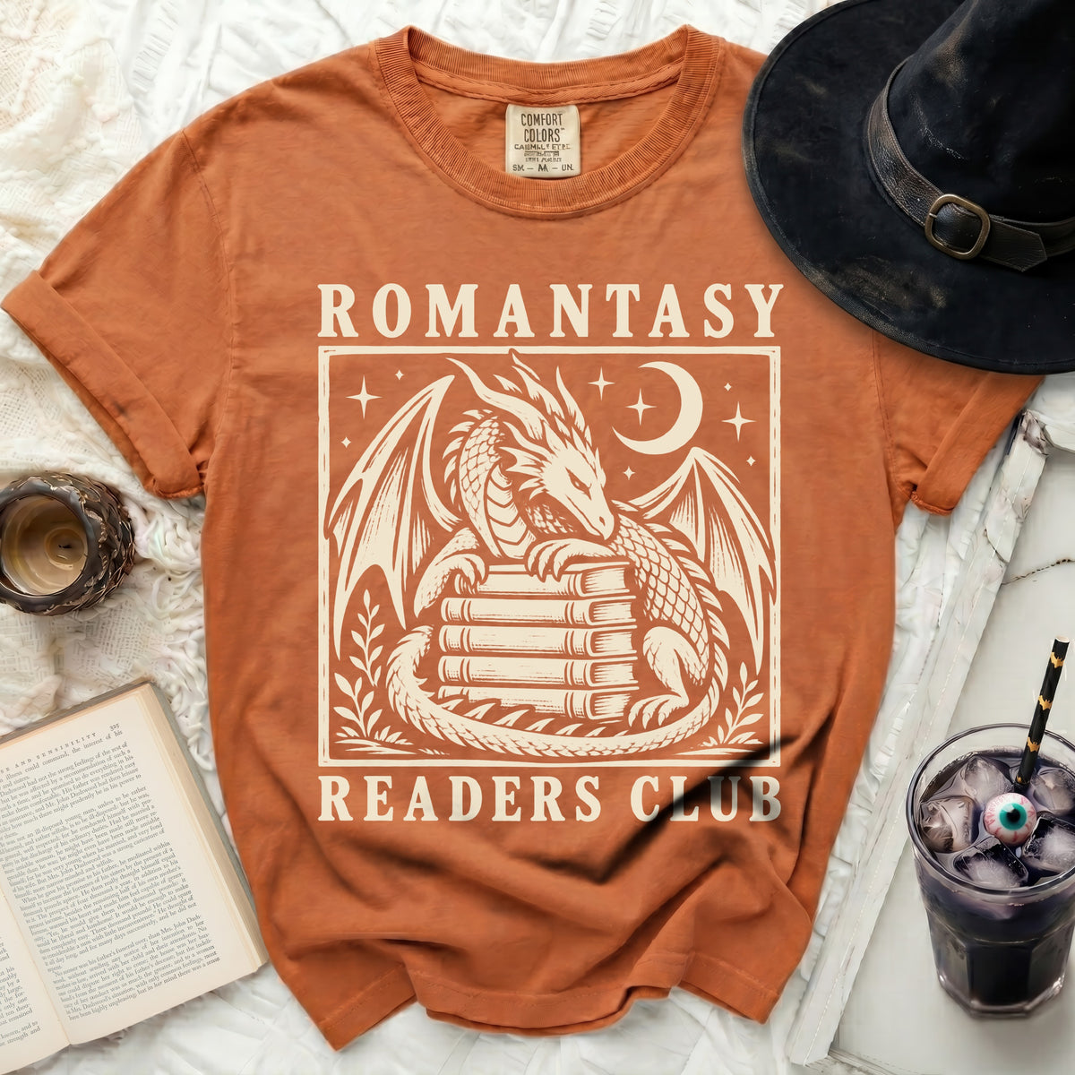Orange t-shirt with "Romantasy Readers Club" and a dragon design.