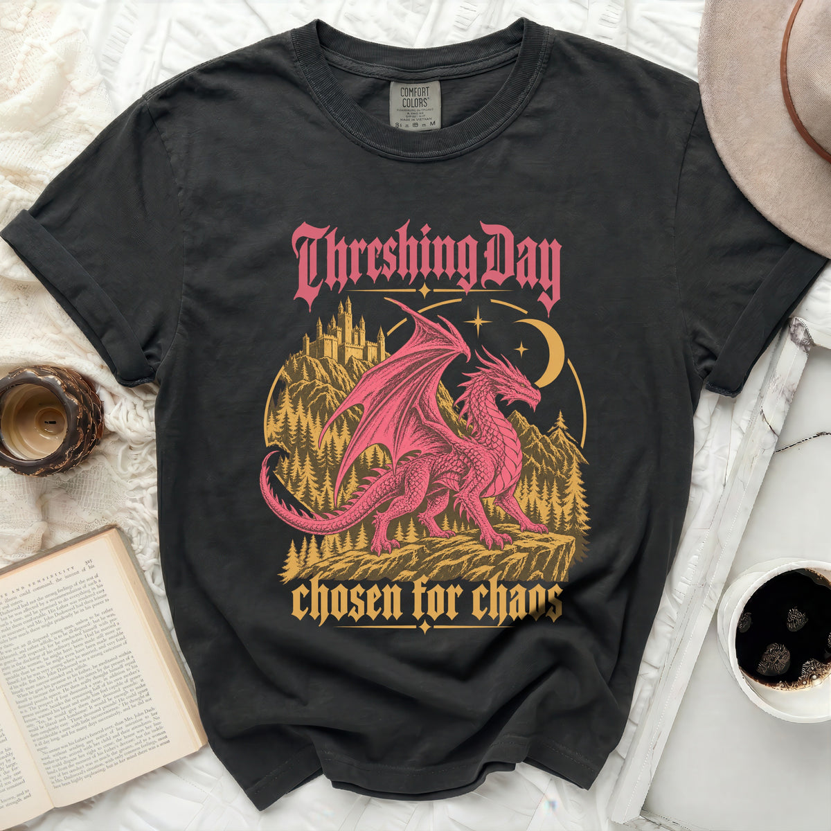 Dark t-shirt with pink dragon, castle, forest, and text "Threshing Day chosen for chaos".