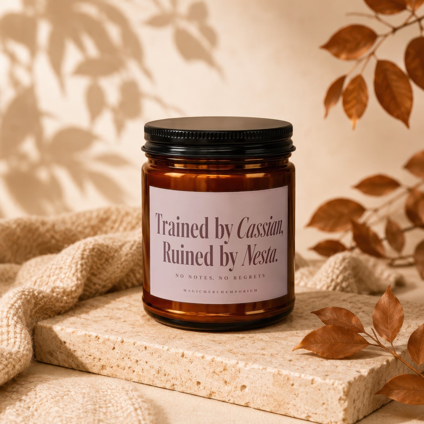 Amber jar candle with label "Trained by Cassian, Ruined by Nesta."