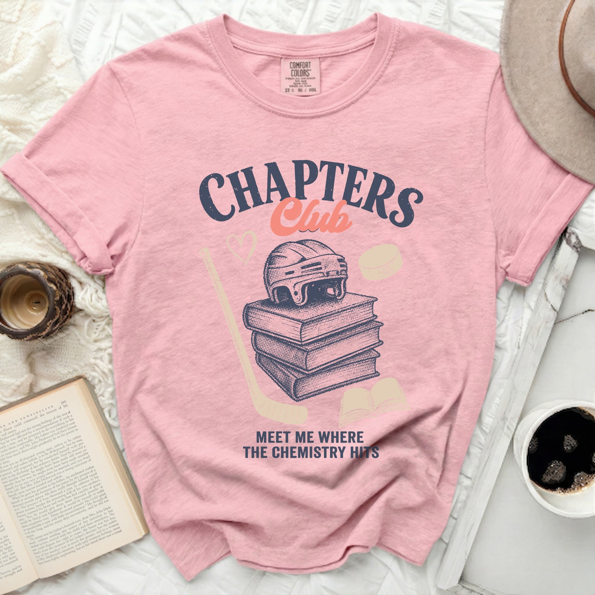 Pink t-shirt with "CHAPTERS Club" and hockey puck graphics.