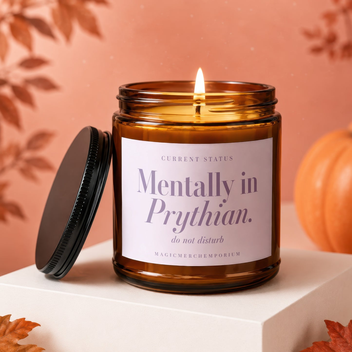 Amber candle with lit wick, lid removed. Label reads "Mentally in Prythian. do not disturb."