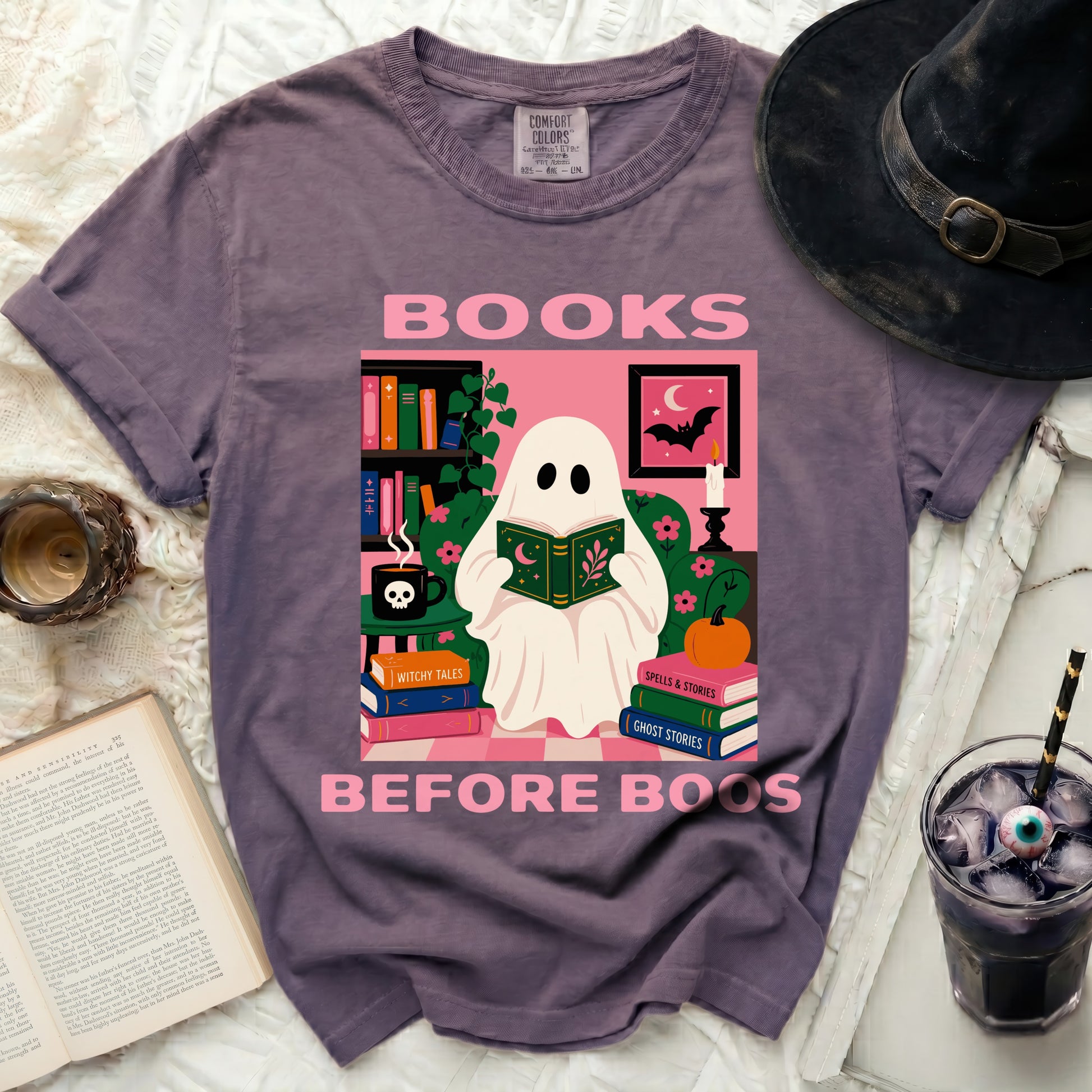 Purple t-shirt with graphic of ghost reading "BOOKS BEFORE BOOS."