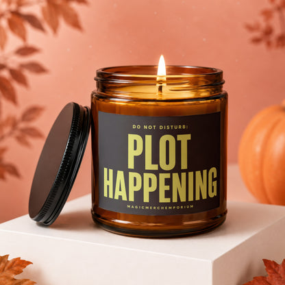 Amber candle with lit wick displaying "DO NOT DISTURB: PLOT HAPPENING".