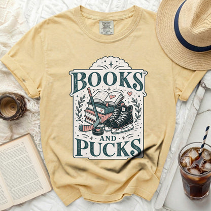Yellow t-shirt with "Books and Pucks" graphic featuring hockey gear and skates.
