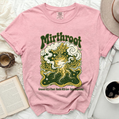 Pink t-shirt with "Mirthroot" and vegetable illustration, "Crescent City's Finest" text.