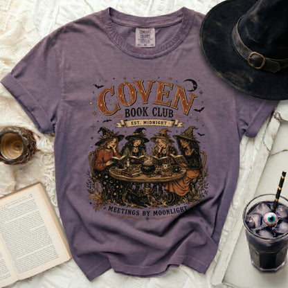 Comfort Colors t-shirt with "Coven Book Club Meetings by Moonlight" graphic.