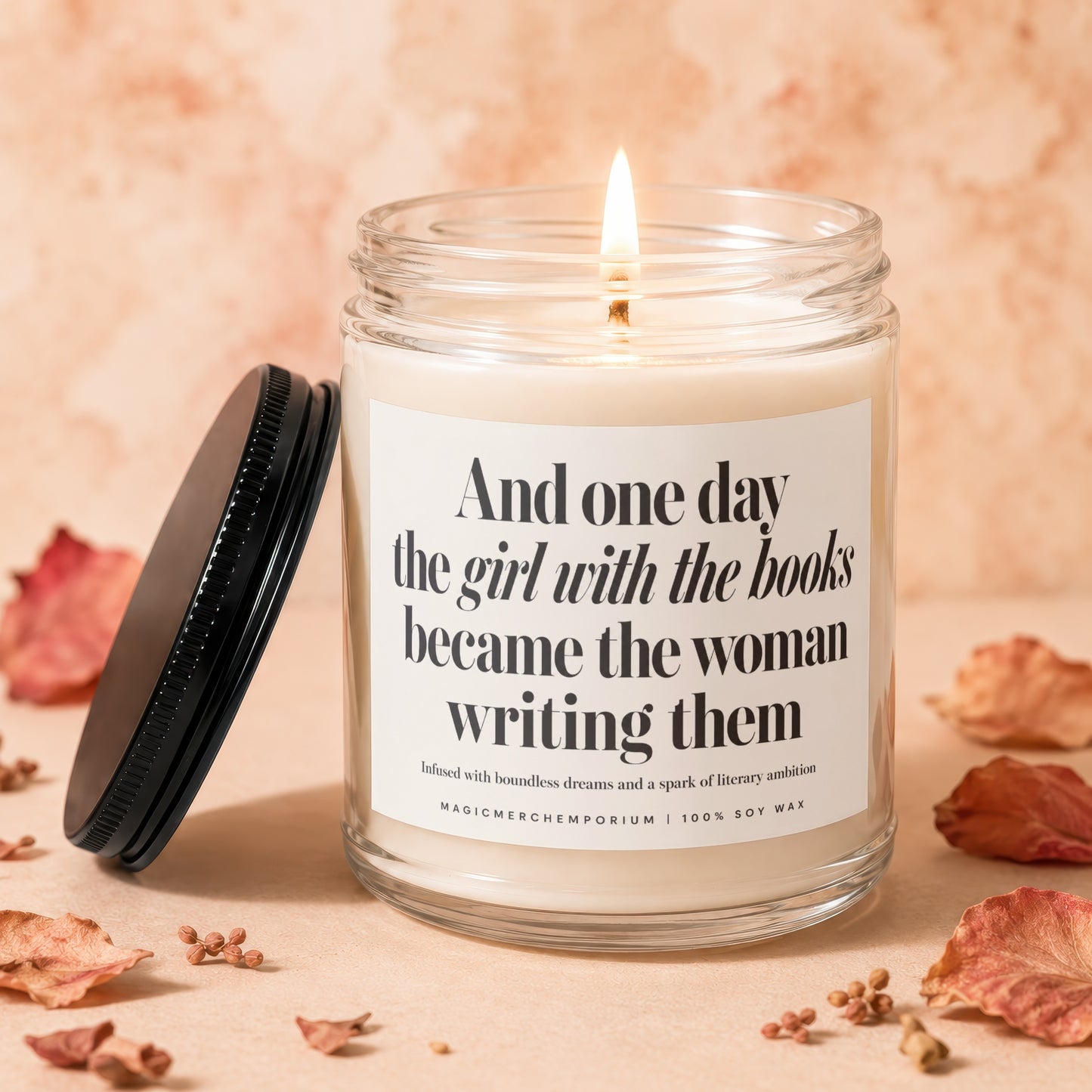 Lit candle with text "And one day the girl with the books became the woman writing them".