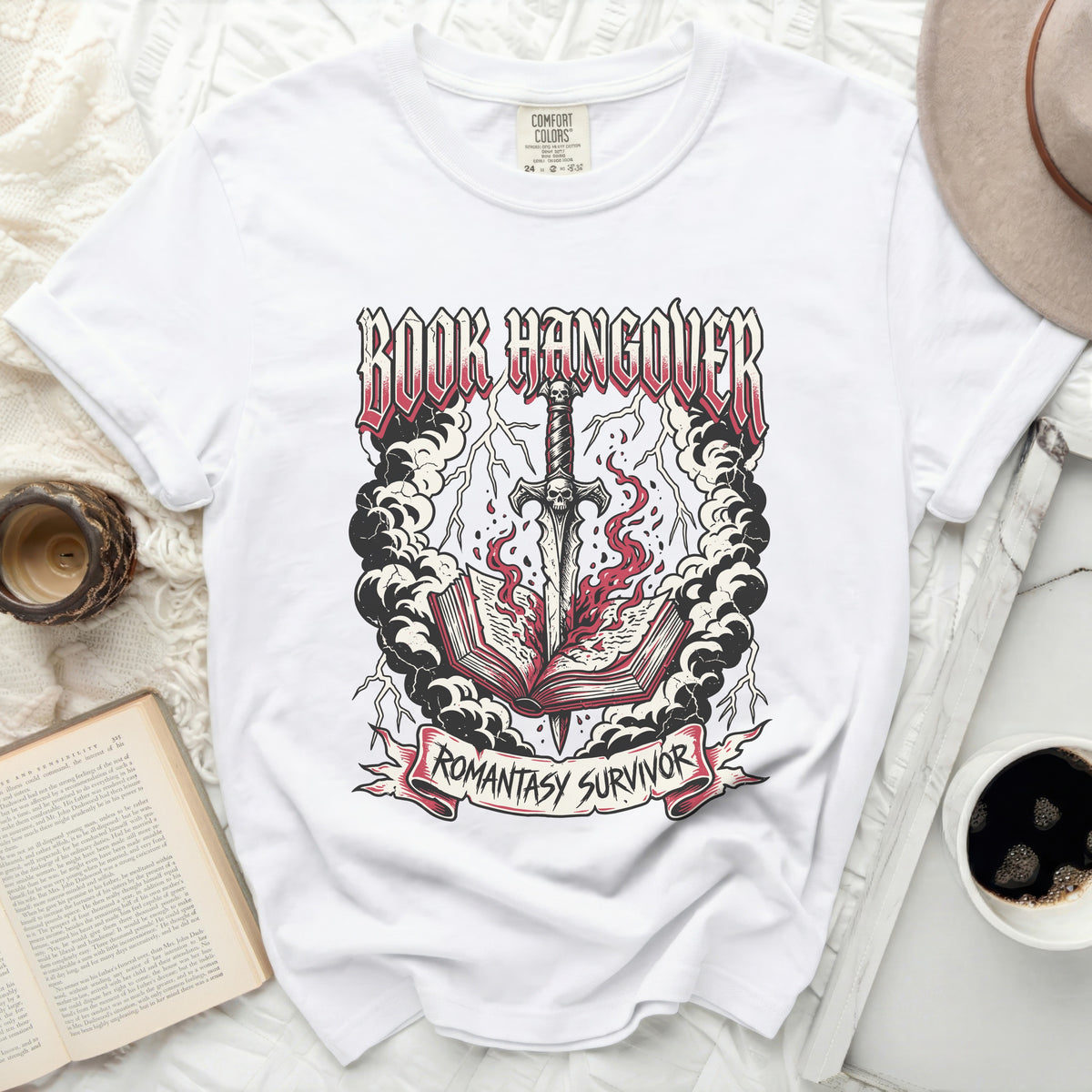 White t-shirt with "BOOK HANGOVER" graphic and a sword through a burning book.