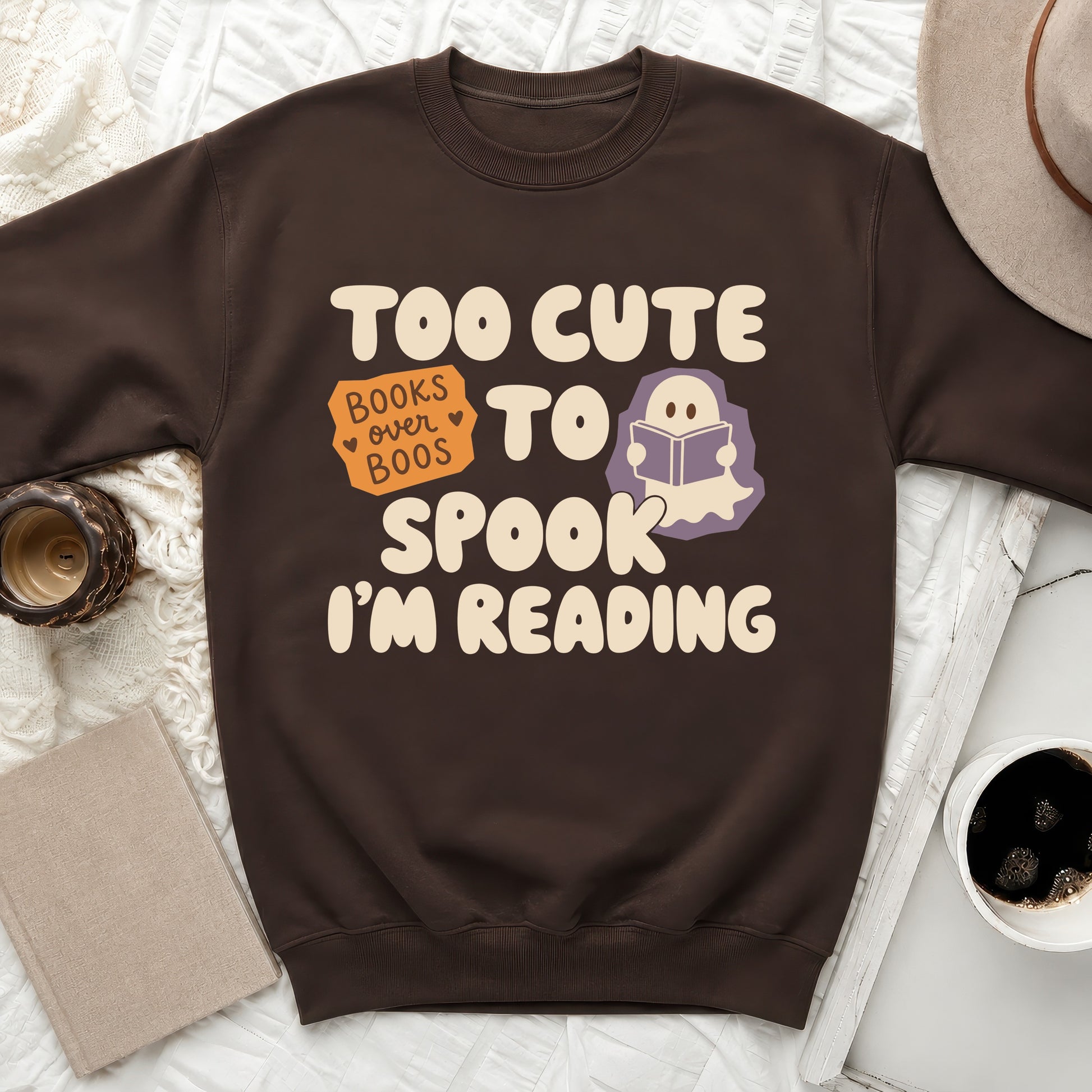 Brown sweatshirt with "Too Cute to Spook" and "Books over Boos I'm Reading" text.
