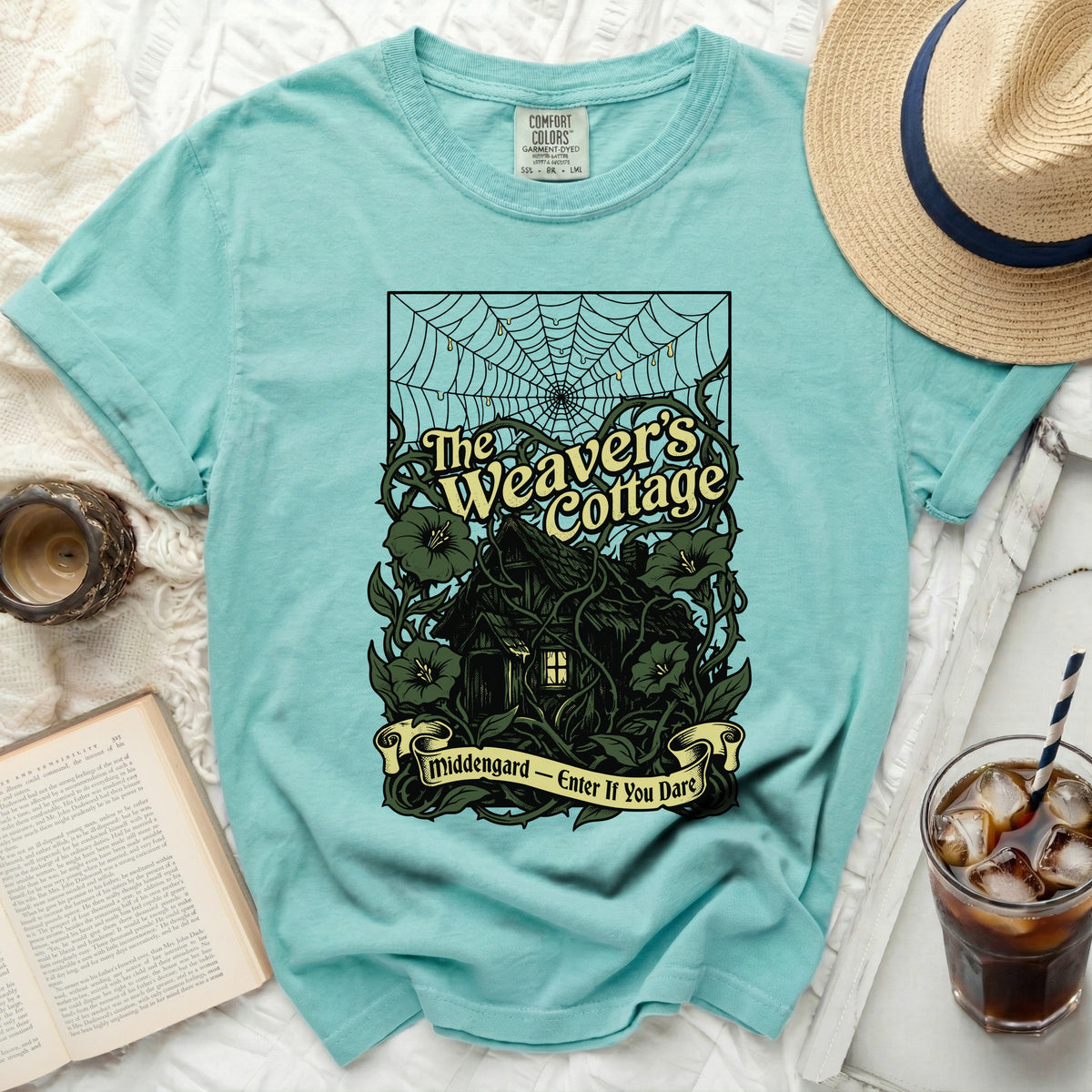 Teal t-shirt with "The Weaver's Cottage" and "Middengard - Enter If You Dare" graphic.