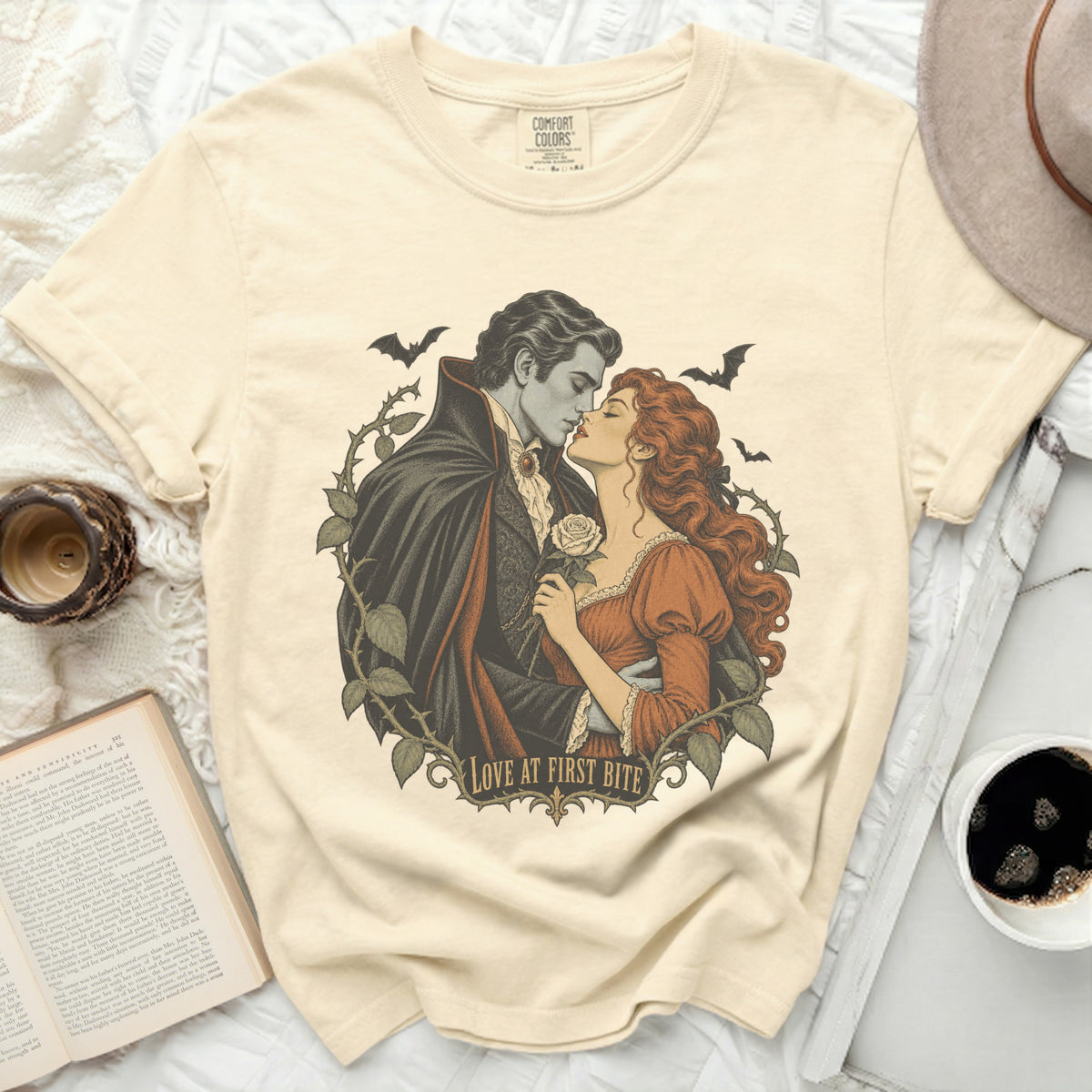 Vampire couple with bats and roses, text "Love at First Bite."