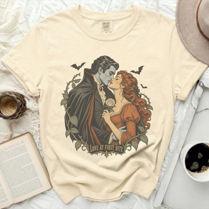 Vampire couple with bats and roses, text "Love at First Bite."