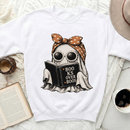 Ghost wearing sunglasses and bandana reading a book, text says "Books Over Boos".
