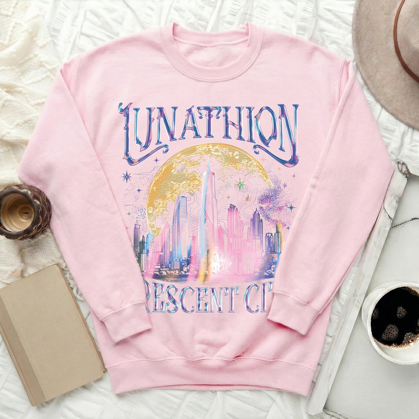 Pink sweatshirt with "Junathion Crescent City" text and a shimmering city skyline graphic.