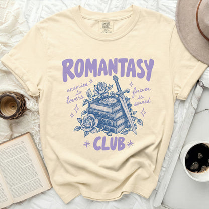 Cream shirt with "ROMANTASY CLUB" text and sword, books, and roses graphic.