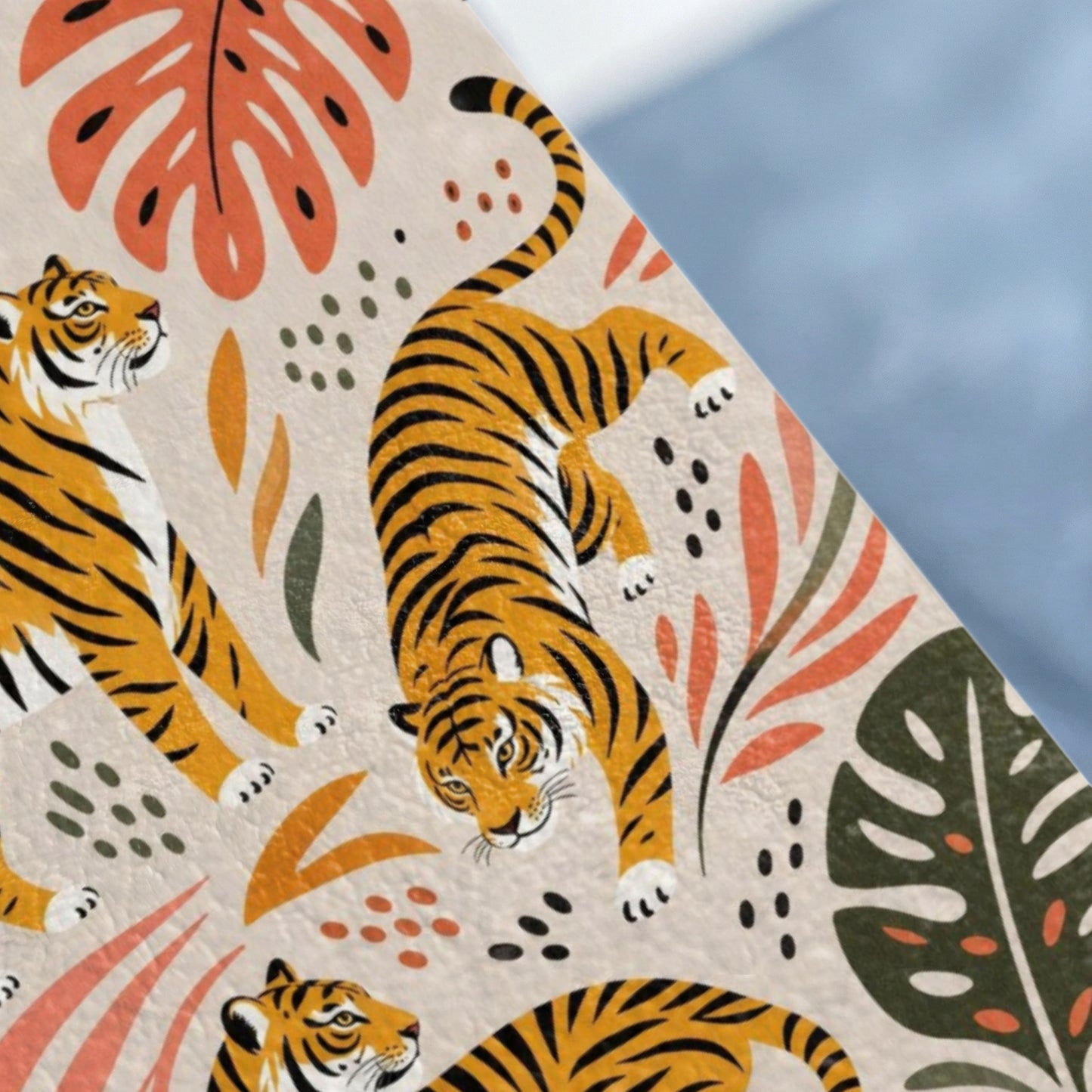 Pattern of stylized tigers and tropical leaves in orange, green, and black on a light background.