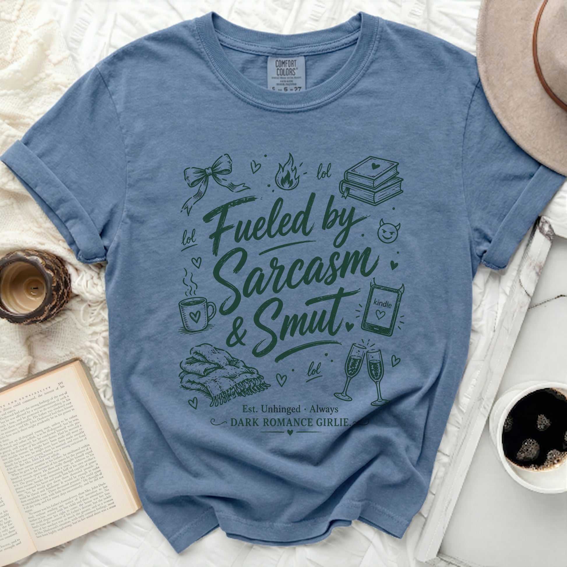 Blue Comfort Colors t-shirt with "Fueled by Sarcasm & Smut" text and icons.