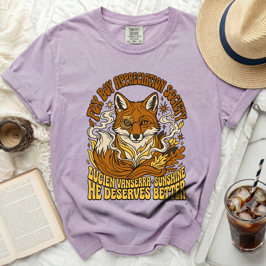 Purple t-shirt with a graphic of a fox wearing a monocle, and text reading "Fox Boy Appreciation Society."