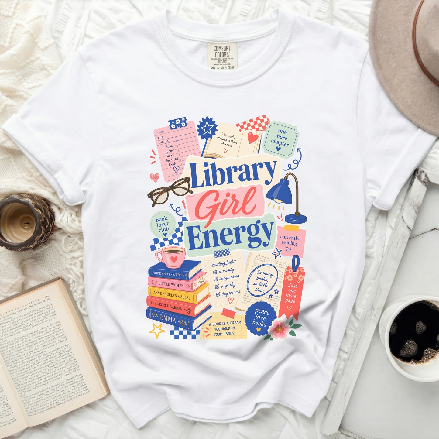 White t-shirt with "Library Girl Energy" graphic and book-themed illustrations.