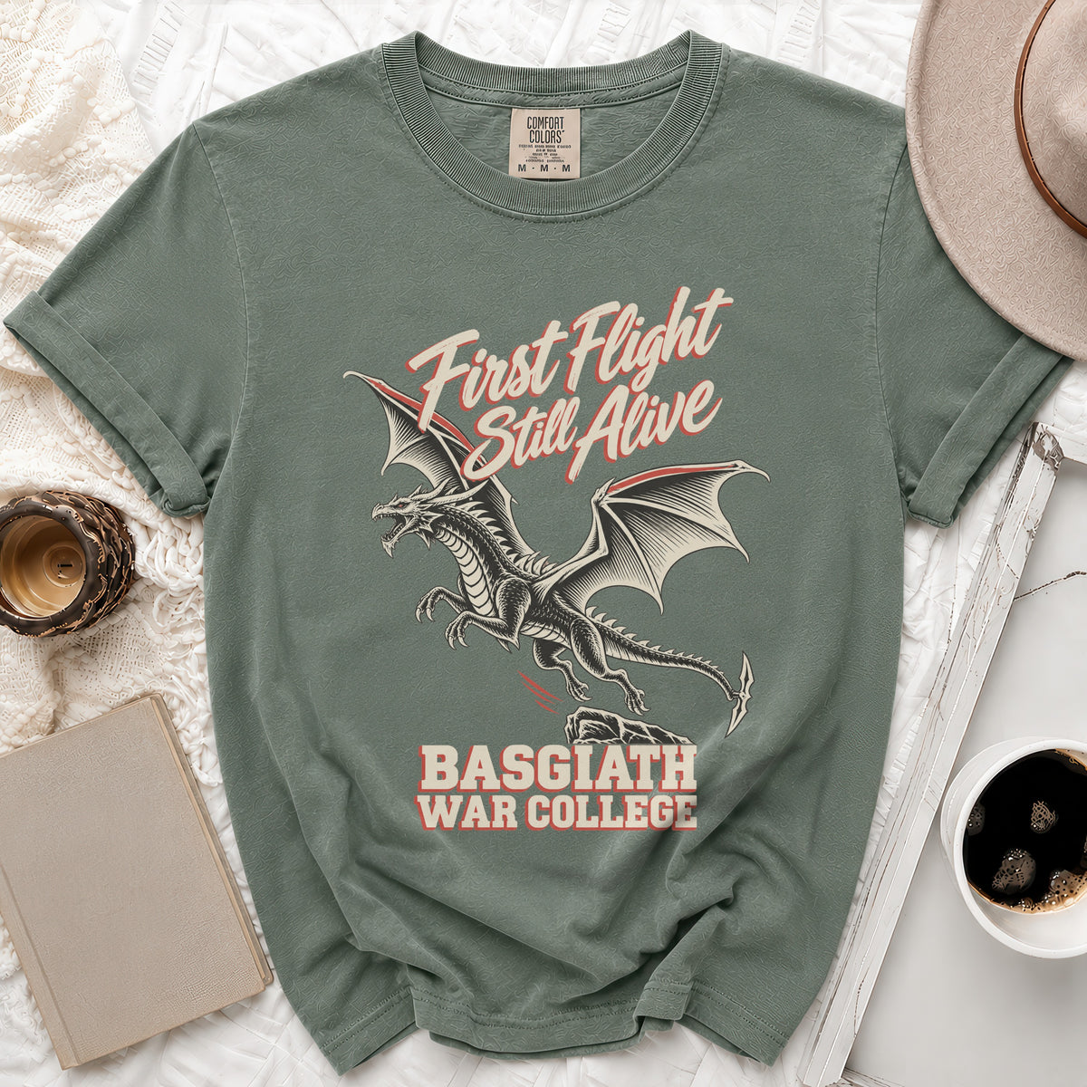 Green t-shirt with dragon graphic and text "First Flight Still Alive Basgiath War College".
