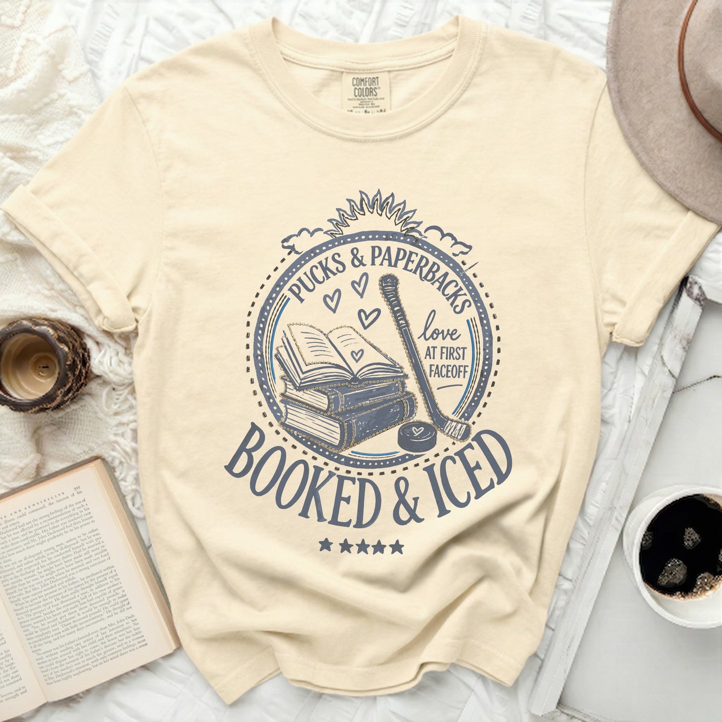 Cream t-shirt with "Booked & Iced" and hockey puck design.