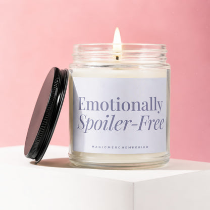 Lit candle in glass jar with black lid, label reads "Emotionally Spoiler-Free".