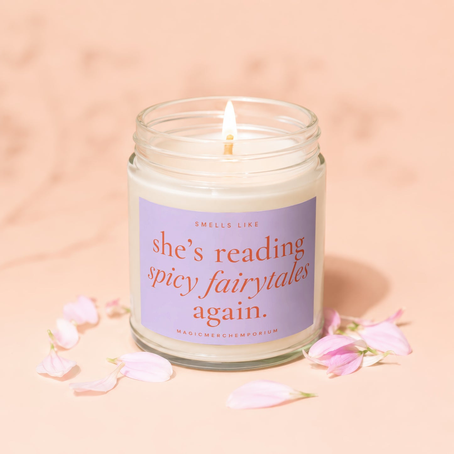 Lit candle in jar with purple label that reads "smells like she's reading spicy fairytales again."