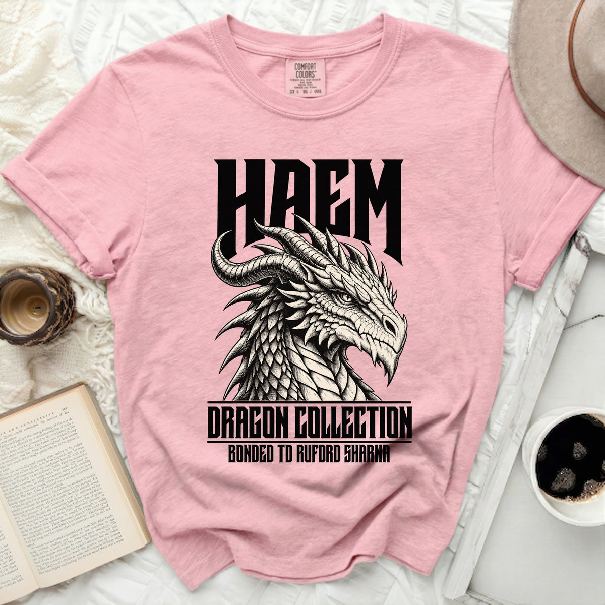 Pink t-shirt with black dragon graphic and text HAEM, DRAGON COLLECTION, BONDED TO RUFORD SHARNA.