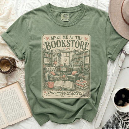 Green t-shirt with "Meet Me at the Bookstore" and cozy library scene.
