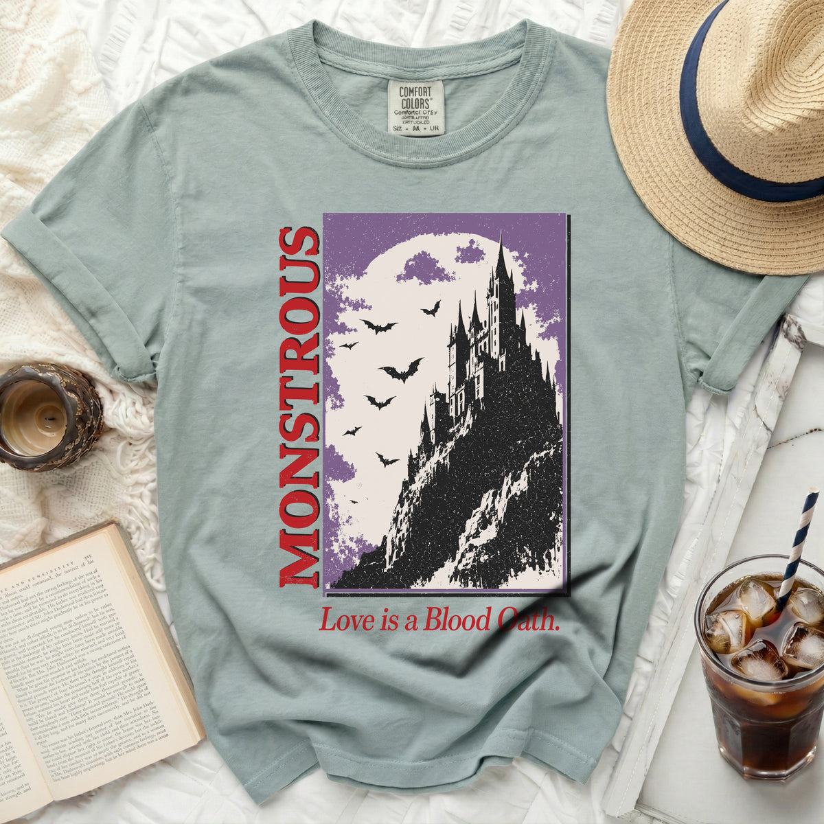 Light green t-shirt with "MONSTROUS" and a castle graphic.