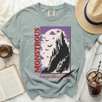 Light green t-shirt with "MONSTROUS" and a castle graphic.