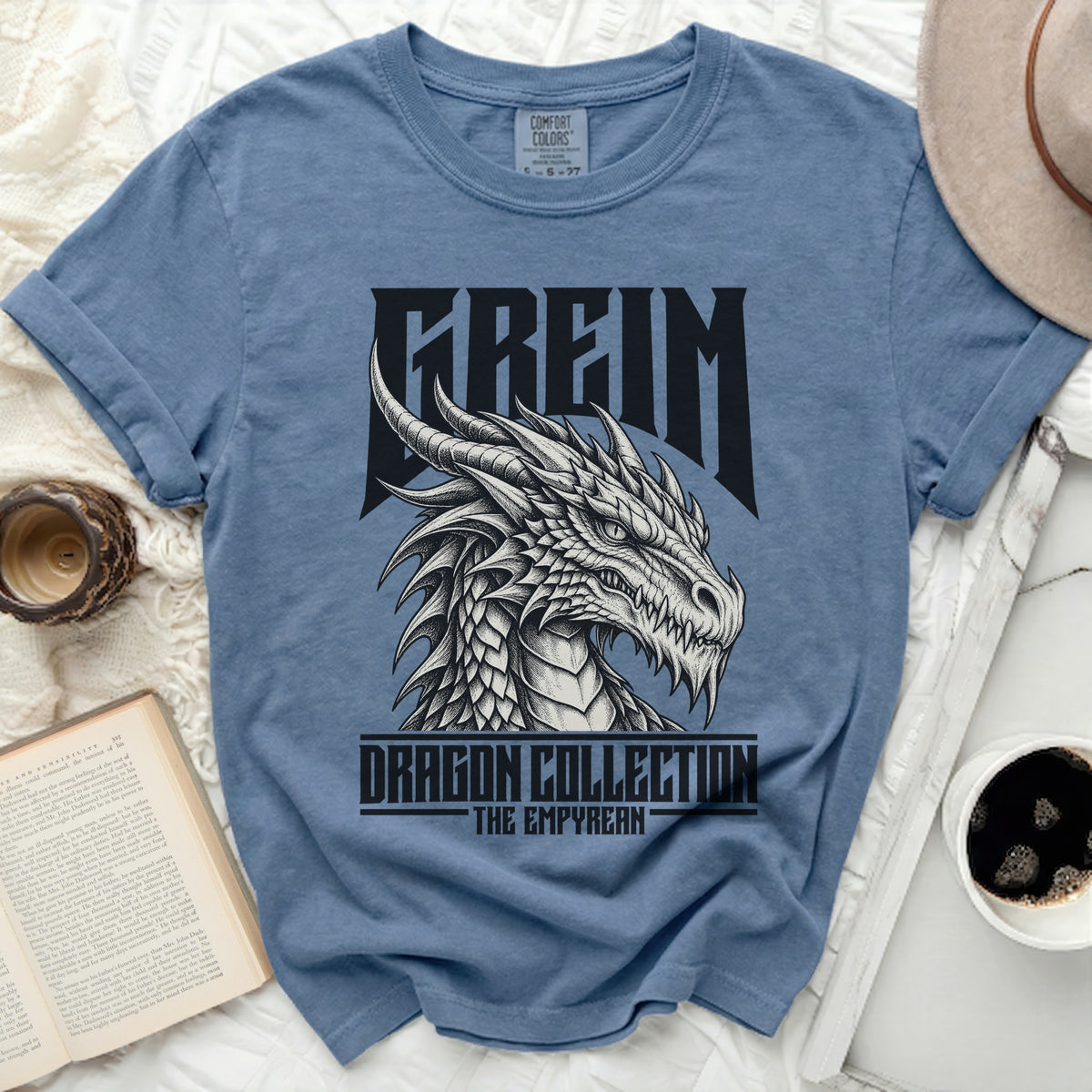 Blue t-shirt with a black dragon graphic and text "FREIM DRAGON COLLECTION THE EMPYREAN".