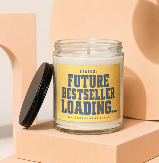 Glass candle with yellow label reading "STATUS: FUTURE BESTSELLER LOADING..."