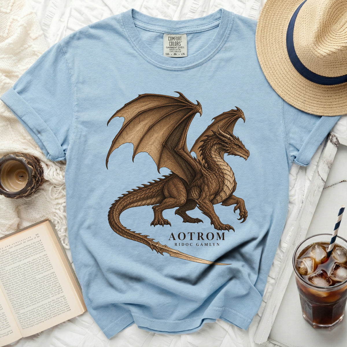 Light blue Comfort Colors t-shirt with brown dragon graphic and text "AOTROM RIDOC GAMLYN".