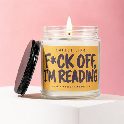 Candle with text "Smells Like F*ck Off, I'm Reading" on a yellow label.